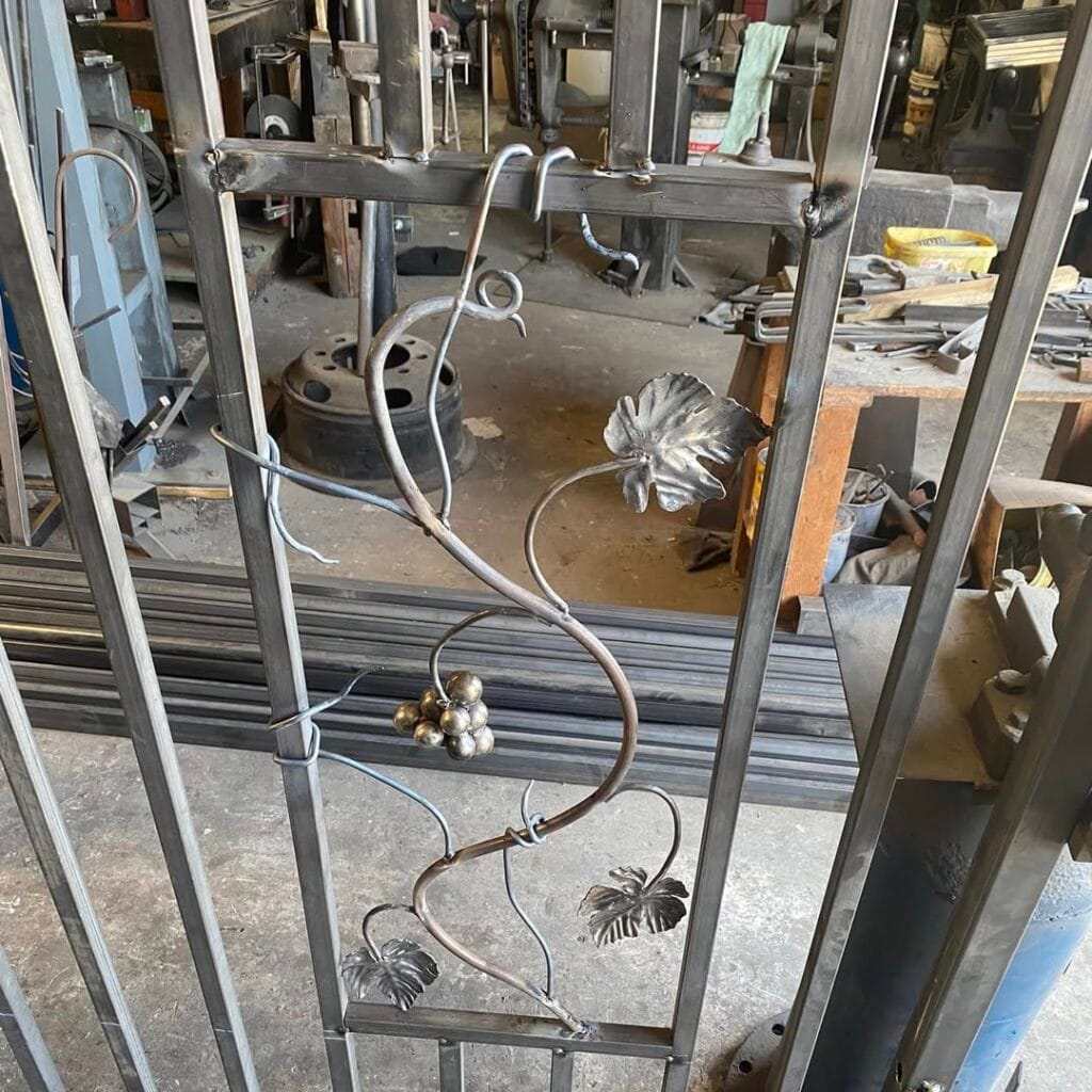 First of 3 panels almost done and held up with a mousehole forge bench vice.