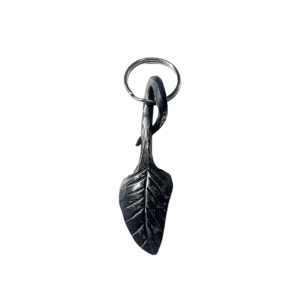 Hand-forged steel keyring shaped like a leaf with detailed veins and a rustic blacksmith finish.